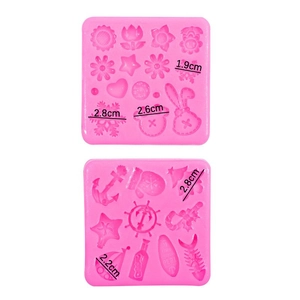 Pink silicone mold featuring Christmas tree, snowflakes, and flowers for DIY fondant and chocolate