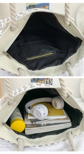Detail view of canvas tote bag interior showing zipper pocket and spacious capacity