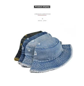 Detail showing four distressed denim bucket hats with frayed edges in different blue washes