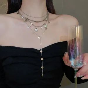 Layered silver shell and sequin chain necklace with y-shaped pendant for women