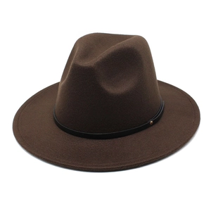 Close-up of a dark brown wool fedora hat with a black leather band and gold stud