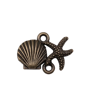 Macro shot of bronze starfish and seashell alloy jewelry connectors for DIY crafting