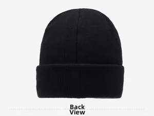 Detail view showing the back profile and ribbed knit texture of the black winter beanie
