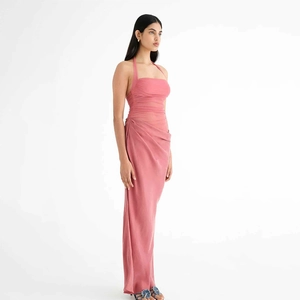 Detailed view of the pink satin halter neck maxi dress with pleated texture on a model