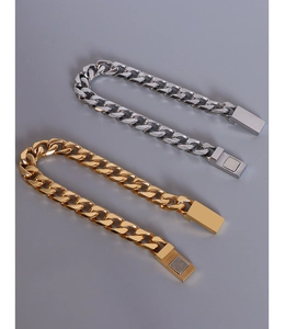 Close-up of flat Cuban link bracelets in gold and silver steel with magnetic clasps
