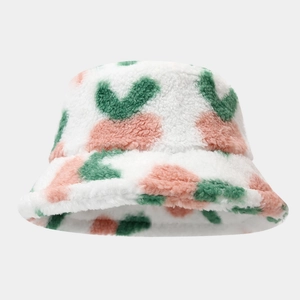 Winter plush bucket hat with pink and green heart print on soft white faux fur material