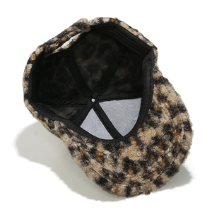 Detail view showing the leopard print faux shearling texture and inner lining of the cap