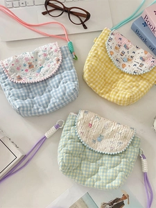 Three colorful quilted crossbody bags with heart pattern and woven straps for travel