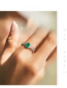 Close-up of s925 silver ring featuring emerald-cut green zircon and leaf diamond accents