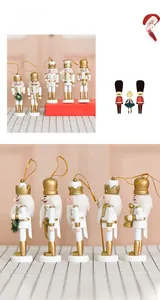 Detail of five 13cm wooden Nutcracker soldier ornaments in white and gold with hanging cords