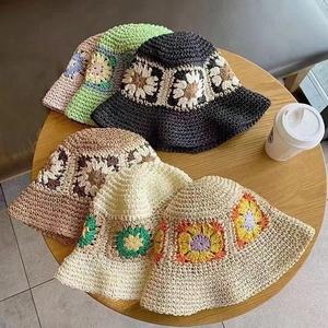Handmade crochet straw bucket hats with floral patterns in multiple summer colors