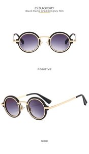 Detail of round punk sunglasses with gold metal bridge and gradient grey lenses