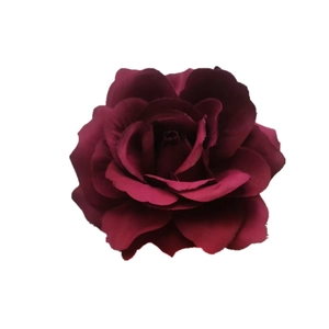 Close-up of deep red artificial silk rose flower with realistic blooming petals