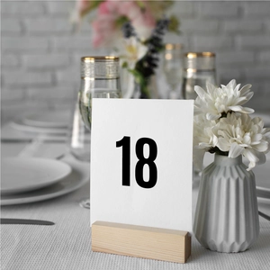 Close-up of minimalist wooden table number holder with card 18 for wedding event