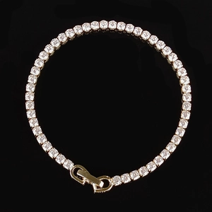 Close-up of hip-hop tennis bracelet with gold finish and white cubic zirconia stones
