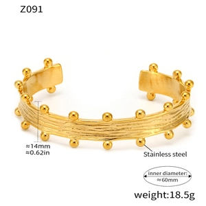 Detailed close-up of 14mm wide 18K gold plated stainless steel cuff with bead texture