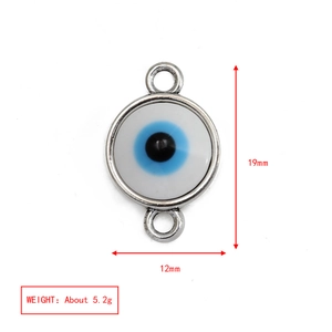 Macro shot of evil eye triangle pendant with dimensions 19mm by 12mm and 5.2g weight