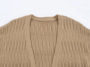 Close-up of khaki knit cardigan featuring a V-neck and detailed vertical rib textures