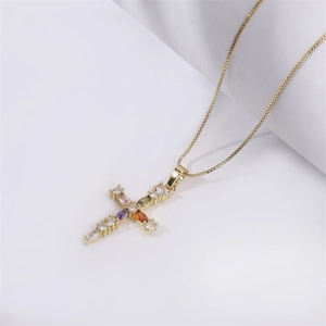 Cross necklace with gold base and colorful stones on a fine golden chain