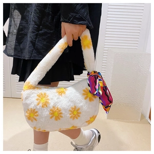 Detail of white plush handbag with daisy floral print and purple silk scarf on the handle