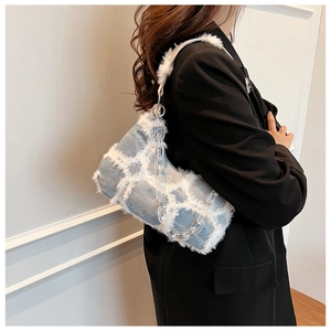 Detail of blue denim shoulder bag with white plush grid and clear acrylic chain strap