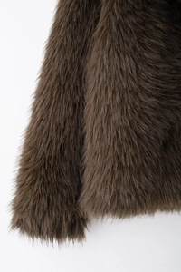 Detailed close-up of dark brown faux fur texture and smooth hair flow on luxury coat