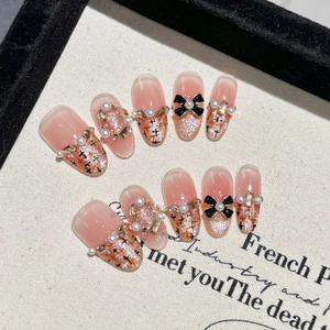 French style caramel tweed press-on nails with cat-eye finish, pearls, and black bows