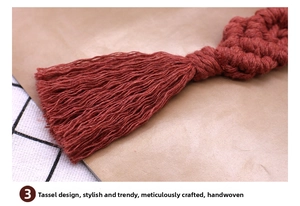 Macro detail of handmade macrame tassel keychain with woven reddish-brown cotton threads