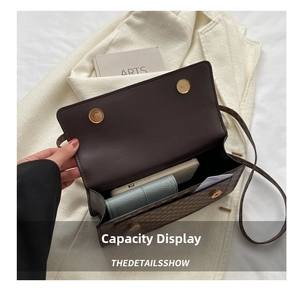 Interior view of small square bag showing storage capacity for smartphone and wallet