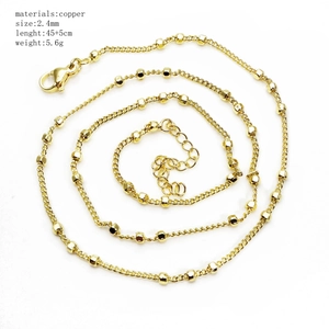 Detailed shot of 45cm+5cm gold copper ball chain with 2.4mm square beads on white background