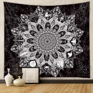 Detail of black and white mandala tapestry with twelve zodiac signs and geometric patterns