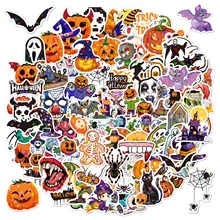 Close-up of various holographic Halloween stickers with pumpkin, ghost and bat designs