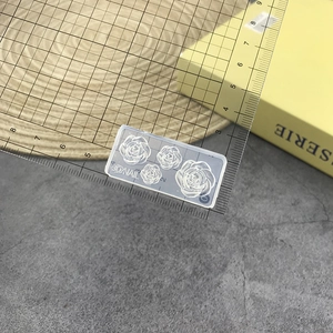 Macro shot showing dimensions of a 3D rose nail art silicone mold with ruler