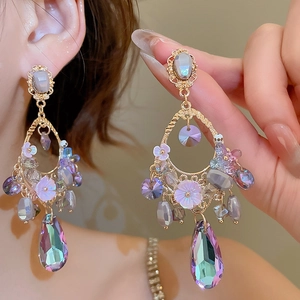 Detailed view of elegant drop earrings featuring colorful crystals and purple floral accents