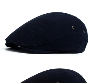 Detailed side view of a navy blue cotton flat cap with breathable metal eyelets