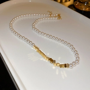 Fashionable pearl choker necklace with gold triangular metal splice and adjustable chain