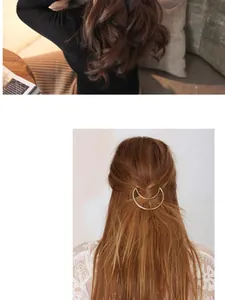 Macro detail of a minimalist golden crescent moon hair clip on wavy brown hair