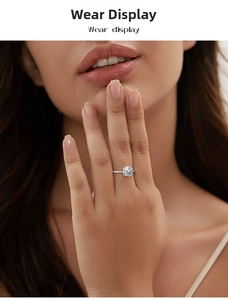 Close-up of 2 carat round moissanite ring with pavé band on woman hand