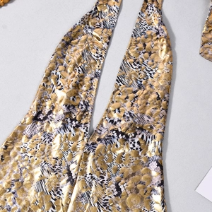 Detailed macro view of the gold metallic foil leopard print and elastic fabric texture