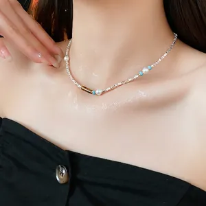 Beaded necklace with silver square beads, pearls, and tiger eye stone worn on collarbone