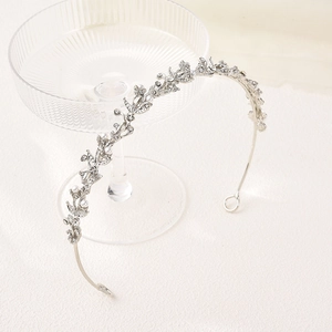 Elegant bridal tiara with vine leaves, white pearls and sparkling rhinestones on silver band