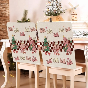 Detail showing pink cartoon motifs and festive text on a beige fabric Christmas chair cover