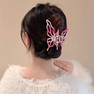 Close-up of pink gradient butterfly hair claw clip with crystal on model hair