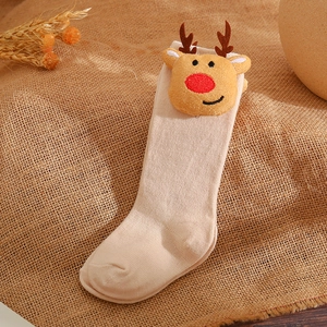 Detailed view of a beige cotton baby sock with a cute 3D plush reindeer head decoration