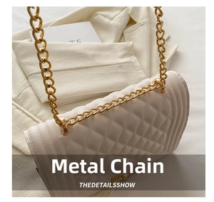 Detail of cream quilted leather bag featuring gold chain strap and metal swivel lock