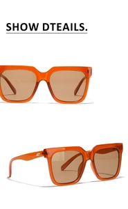 Detail view of oversized orange frames with brown lenses and gold metal side accents