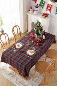 Festive red and green plaid Christmas tablecloth in a cozy holiday dining room setting