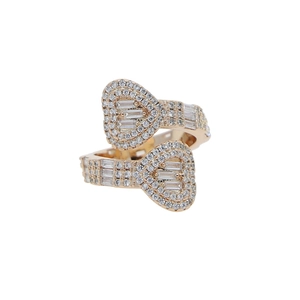 Detailed close-up of bypass heart ring in rose gold with baguette and round zircons
