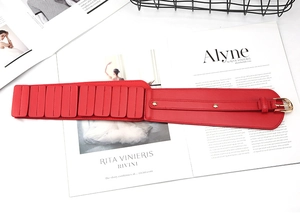 Detail view of the red PU leather wide corset belt with golden buckle and textured blocks