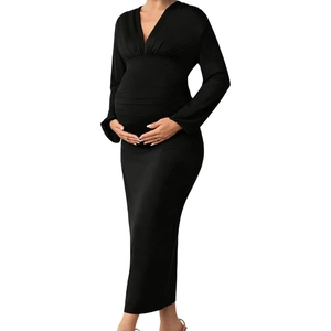 Detail of black V-neck maternity dress with long sleeves and pleated bodycon fit